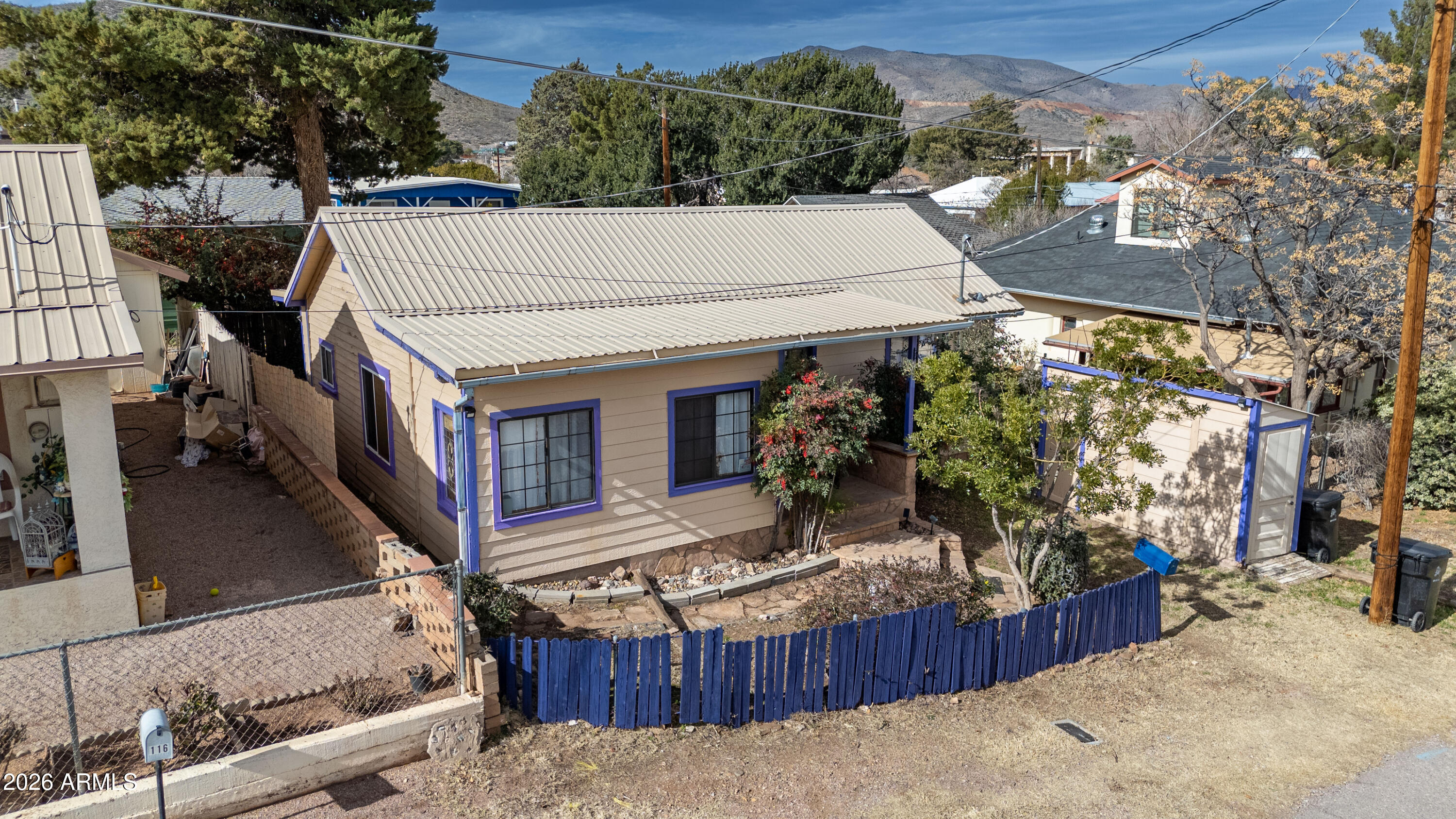 a view of a house with wooden fence
