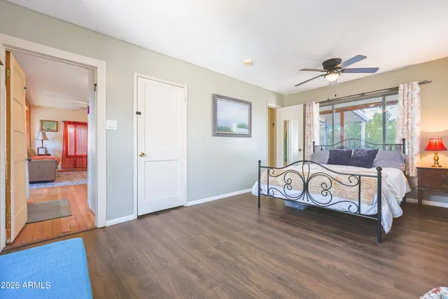 a spacious bedroom with a bed and a large window