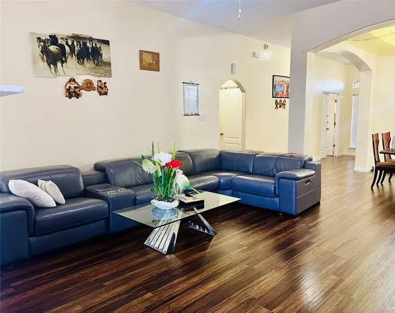 a living room with furniture wooden floor and a table