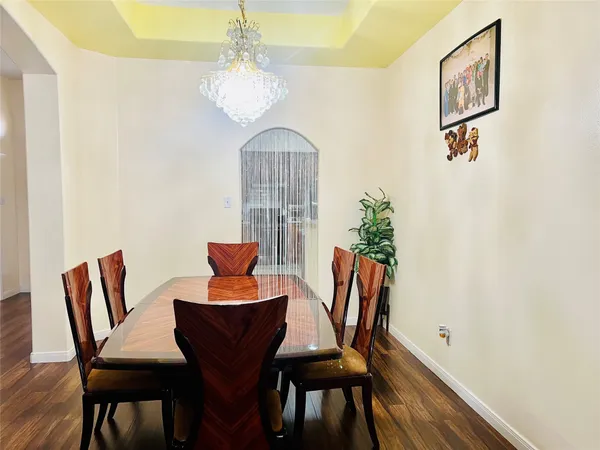 a view of a dining room with furniture and chandelier