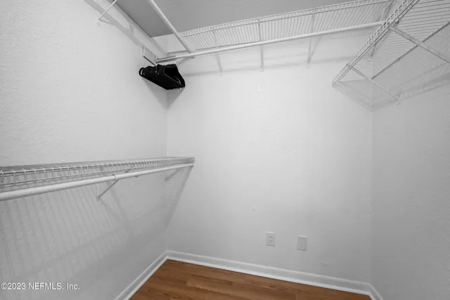 a living room with furniture a clock and a ceiling fan