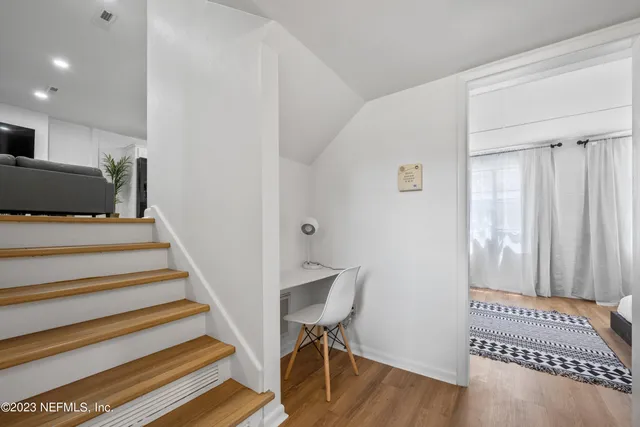 a view of a yard with a house and a large tree