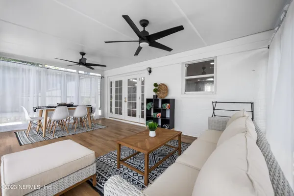 a view of small yard in front of house with seating space