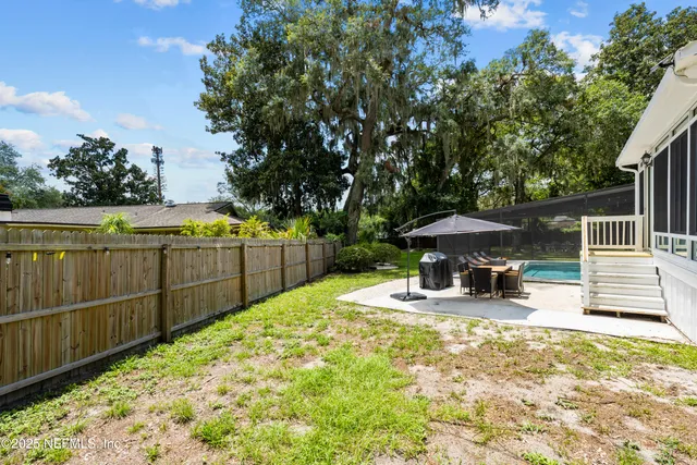 a living room with furniture and a view of kitchen