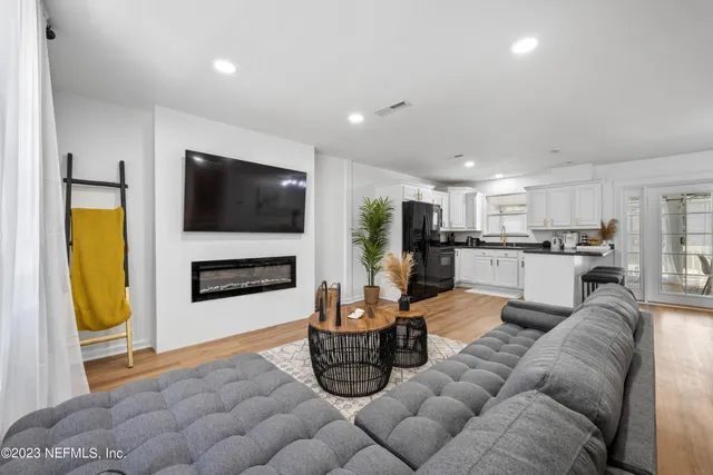 a kitchen with refrigerator and cabinets