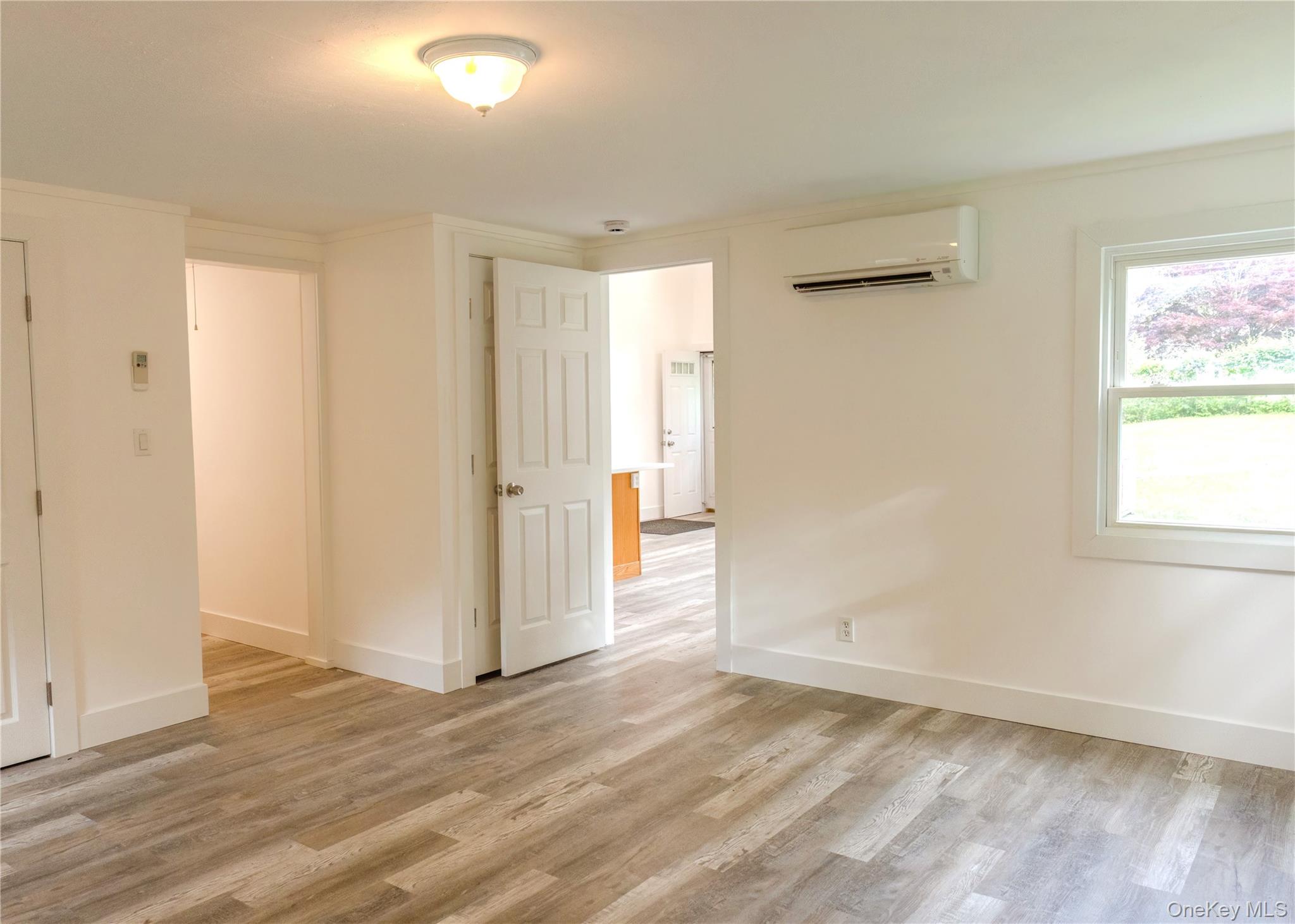 23 Lucille Road Carmel, NY 10512 - Photo 20 of 44 an empty room with wooden floor and windows