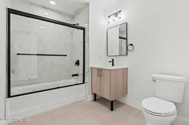 a bathroom with a toilet sink and shower