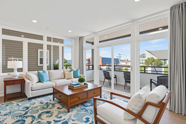 a living room with furniture and a floor to ceiling window