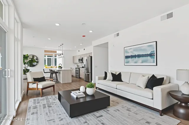 a living room with furniture a rug and a table