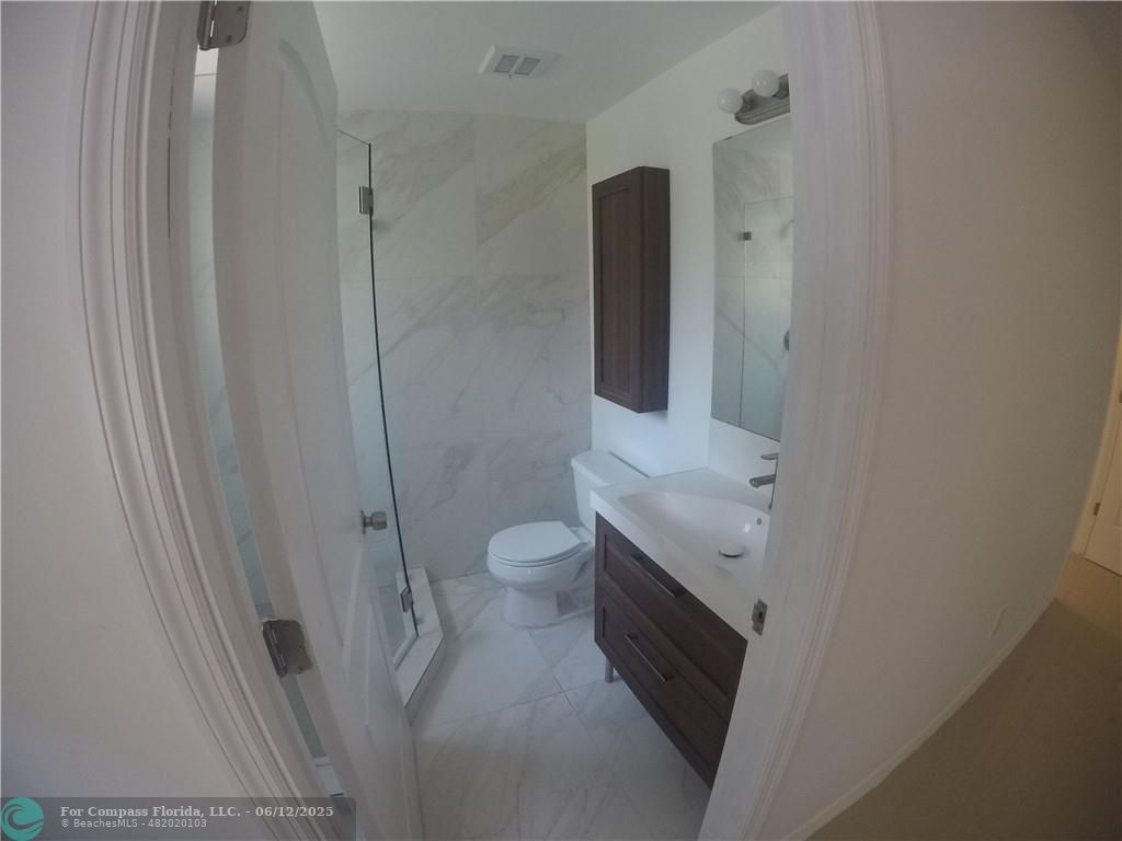 1611 Michigan Avenue, Unit 2 Miami Beach, FL 33139 - Photo 11 of 15 a bathroom with a toilet sink and shower