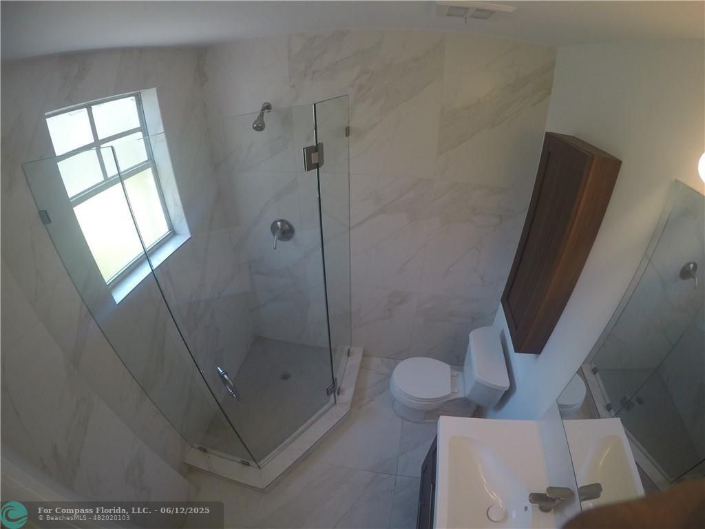 1611 Michigan Avenue, Unit 2 Miami Beach, FL 33139 - Photo 13 of 15 a bathroom with a shower and toilet