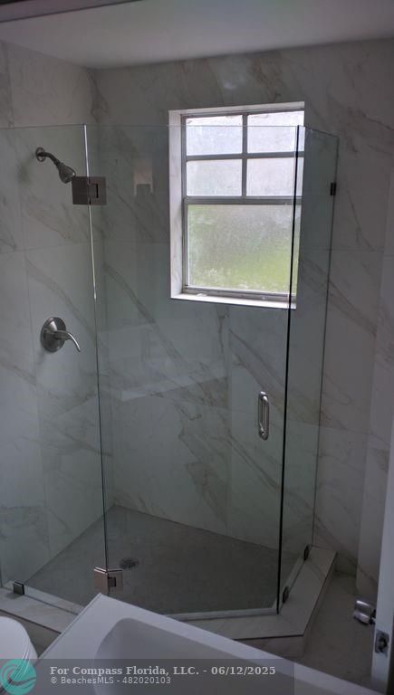 1611 Michigan Avenue, Unit 2 Miami Beach, FL 33139 - Photo 14 of 15 a bathroom with a shower