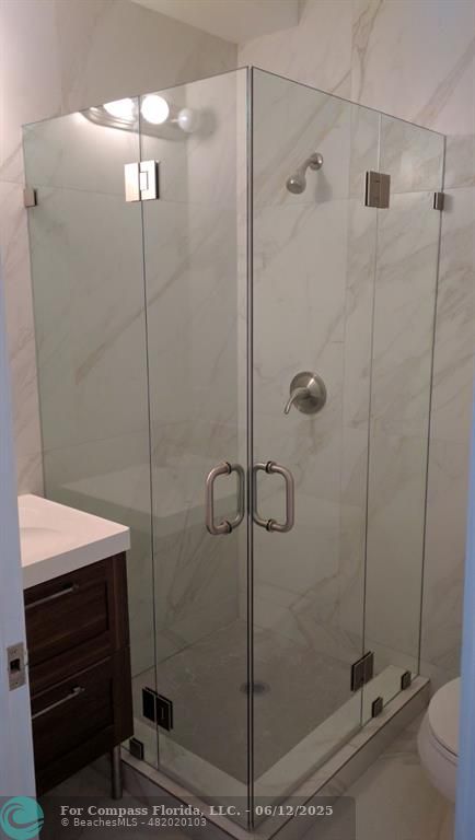 1611 Michigan Avenue, Unit 2 Miami Beach, FL 33139 - Photo 15 of 15 a bathroom with a shower a toilet and sink