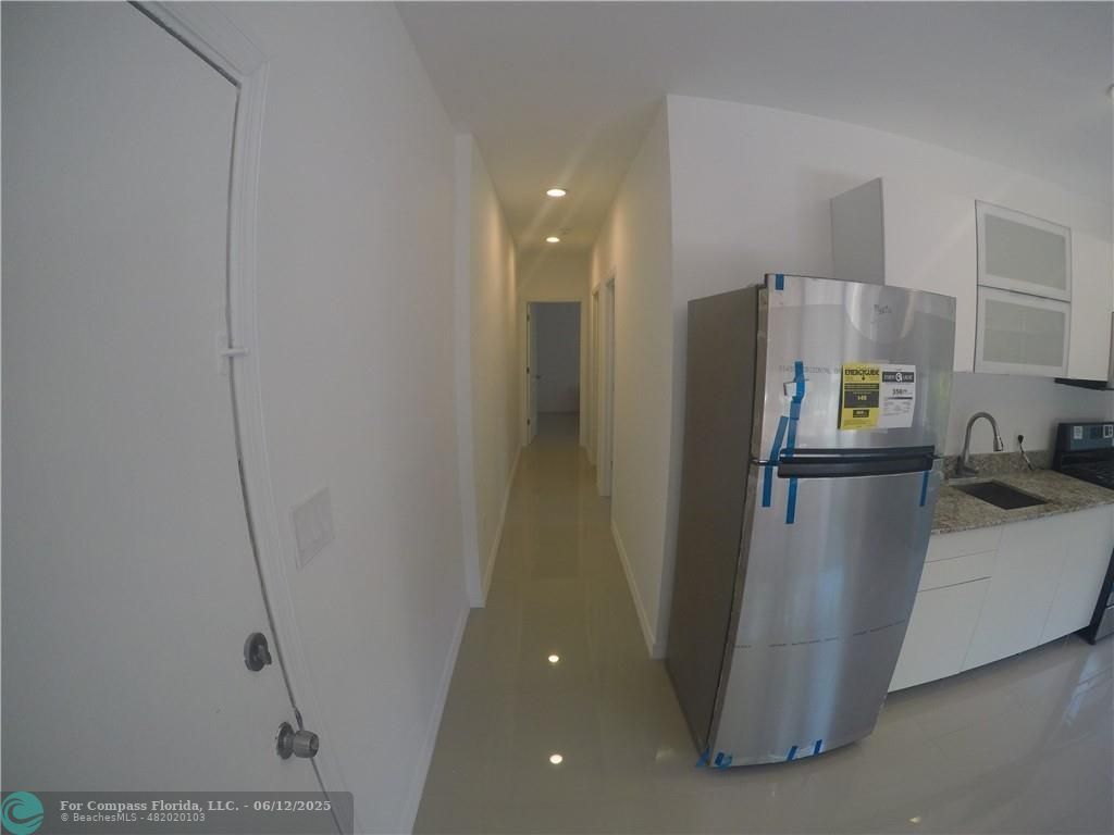1611 Michigan Avenue, Unit 2 Miami Beach, FL 33139 - Photo 6 of 15 a kitchen with refrigerator and faucet