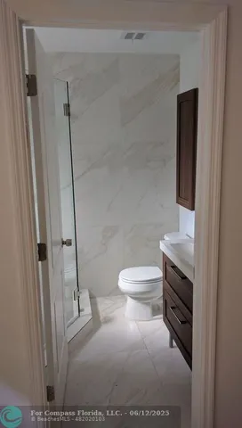 a bathroom with a sink a toilet and mirror