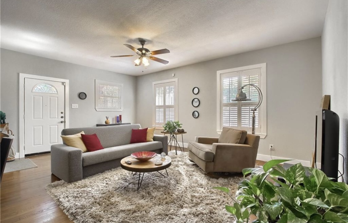 702 West N Loop Boulevard Austin, TX 78751 - Photo 13 of 23 A welcoming living area with rich hardwood floors and multiple sources of natural light.