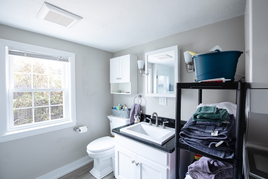 36 Lovell's Lane Mashpee, MA 02649 - Photo 11 of 23 a bathroom with a granite countertop sink a toilet and a window