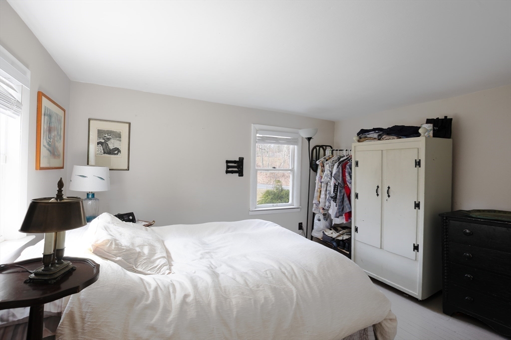 36 Lovell's Lane Mashpee, MA 02649 - Photo 12 of 23 a bedroom with a bed and a lamp