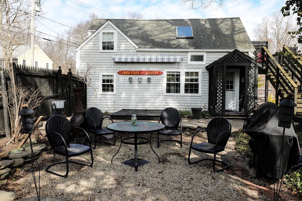 36 Lovell's Lane Mashpee, MA 02649 - Photo 16 of 23 a view of a house with backyard and sitting area