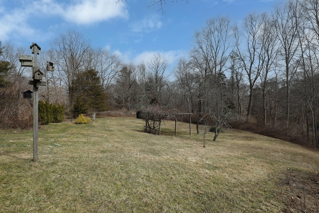 36 Lovell's Lane Mashpee, MA 02649 - Photo 19 of 23 a view of a bench in a backyard