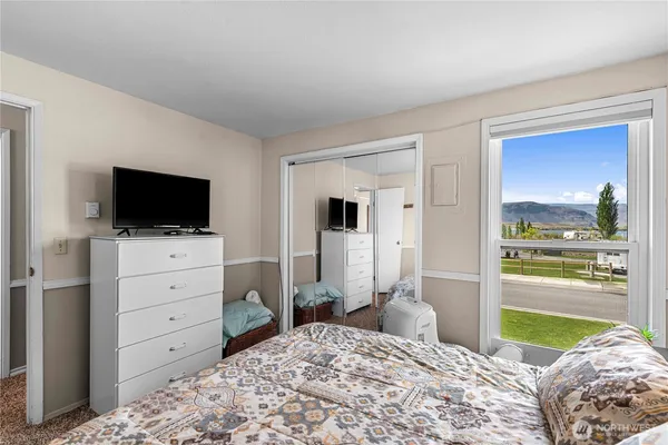 a bedroom with a bed and closet