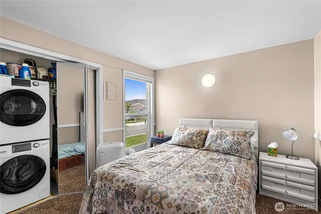 a view of a bedroom with bed and workspace