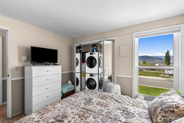 a bed room with a bed and a chair