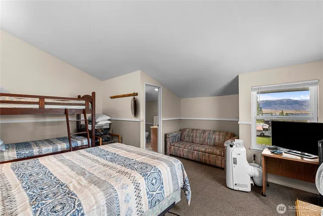 a bedroom with a large bed and a couch