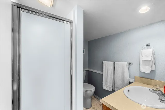 a bedroom with furniture and a flat screen tv