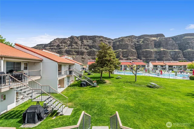 a view of a house with a yard and sitting area