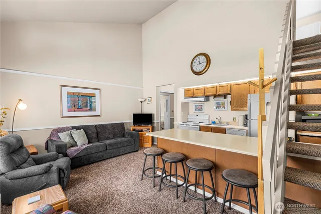 a living room with furniture a rug and a window