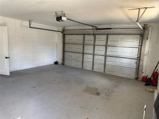 a view of a house with a yard and large tree