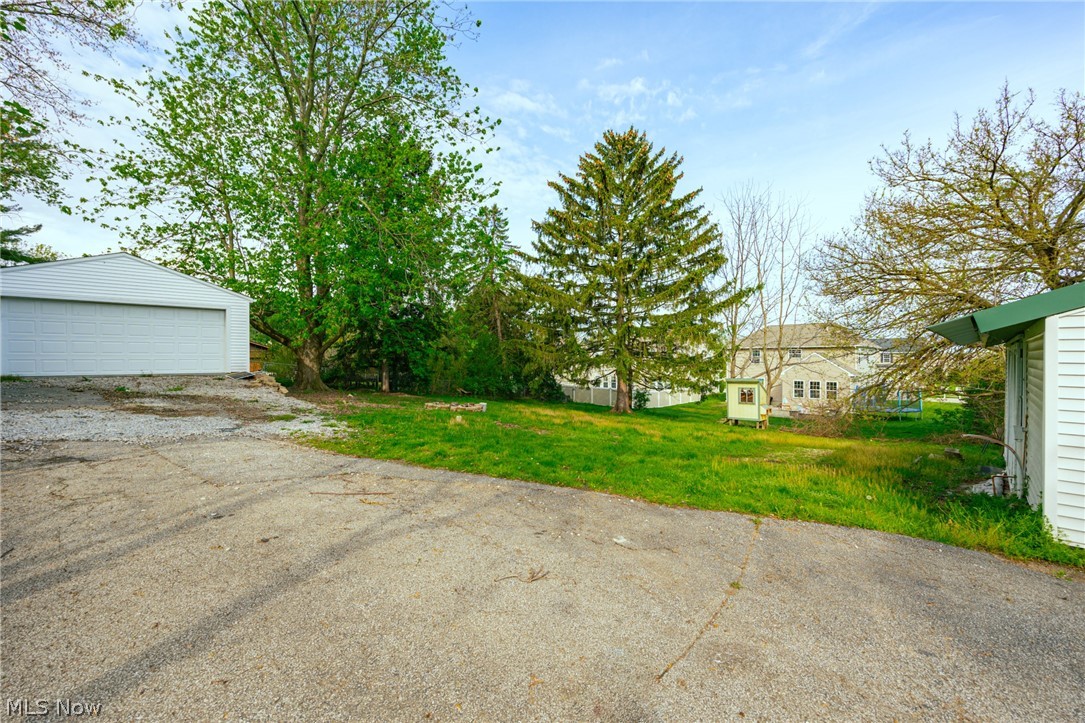 39016 Detroit Road Avon, OH 44011 - Photo 33 of 36 View of yard featuring a garage and an outdoor structure