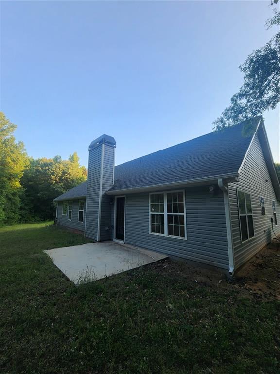 435 Butler Bridge Circle Covington, GA 30016 - Photo 25 of 25 a front view of a house with a garden