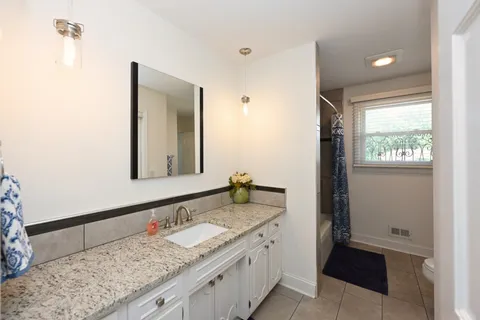 a bathroom with a sink a mirror and a shower