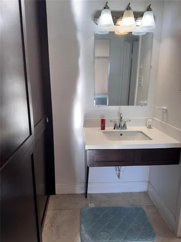 a bathroom with a sink vanity and mirror