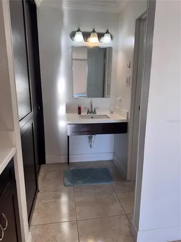 a bathroom with a sink a mirror and a vanity