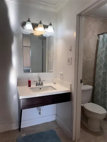 a bathroom with a toilet a sink and mirror