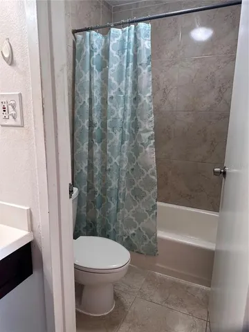 a bathroom with a toilet and shower