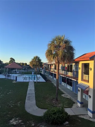 a view of a house with a yard and sitting area