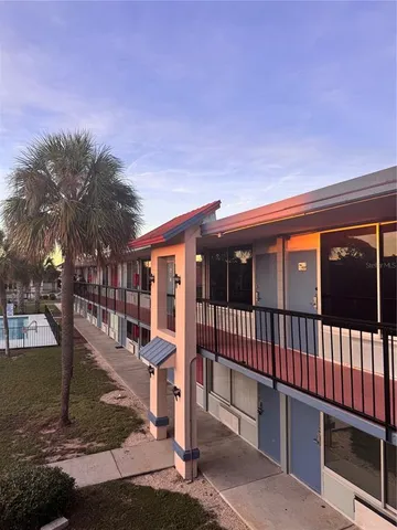 a view of a house with backyard porch and sitting area