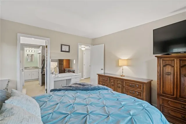 a bedroom with a bed and a flat screen tv in it