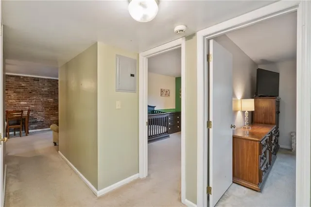 a view of a hallway with living room and dining room view