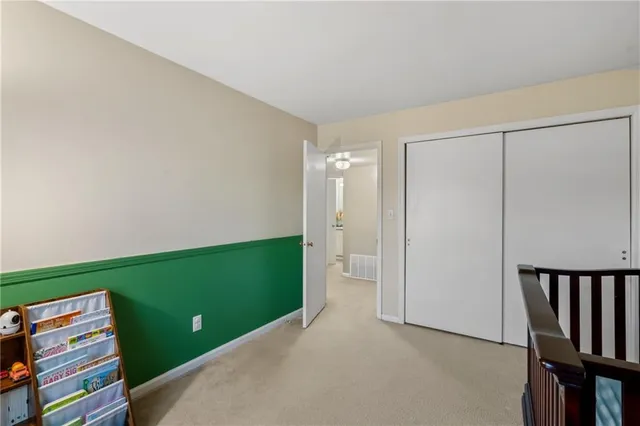 a view of an empty room and wooden floor