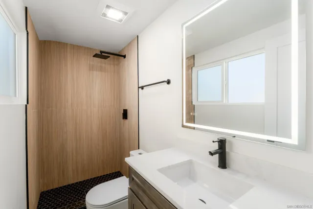 a bathroom with a sink toilet and shower