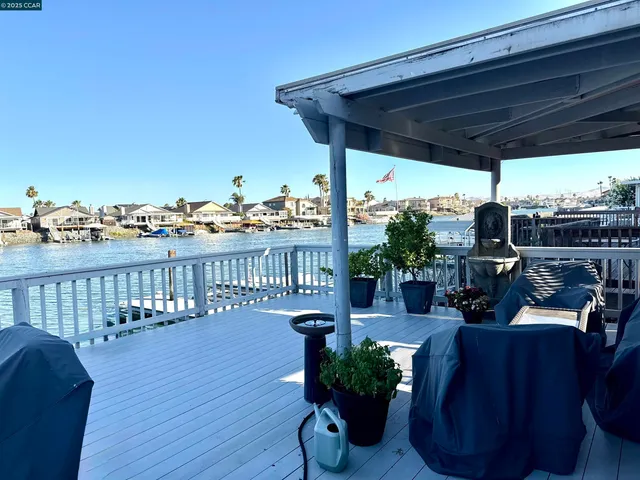 a view of a balcony with chairs and wooden floor