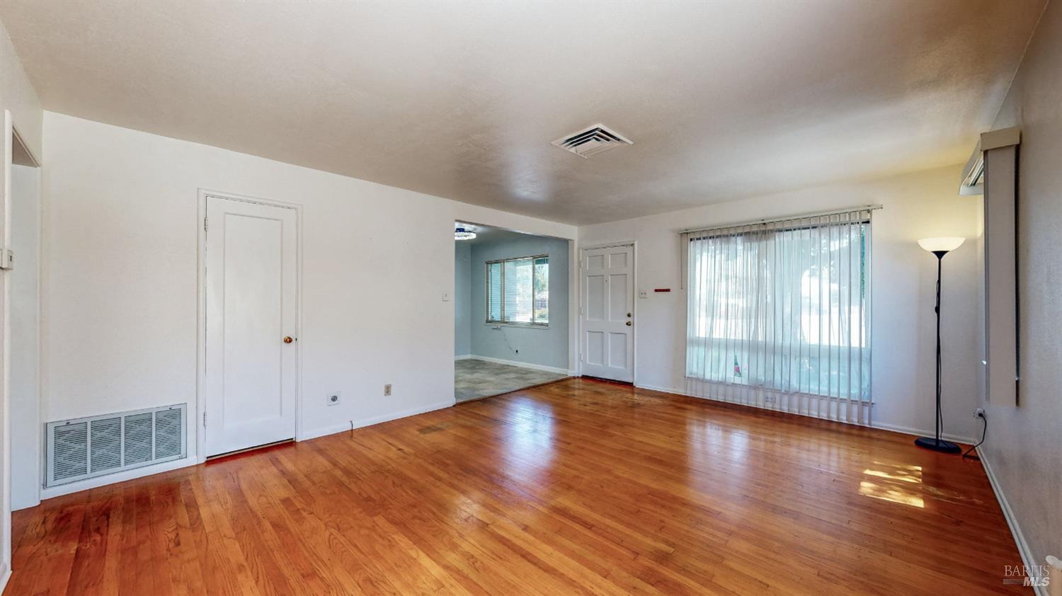 809 Maple Avenue Vallejo, CA 94591 - Photo 6 of 46 a view of empty room with wooden floor and fan
