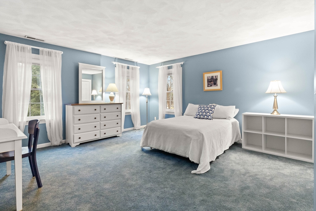 3 Woodland Road Boxford, MA 01921 - Photo 13 of 37 a spacious bedroom with a bed and a lamp on dresser