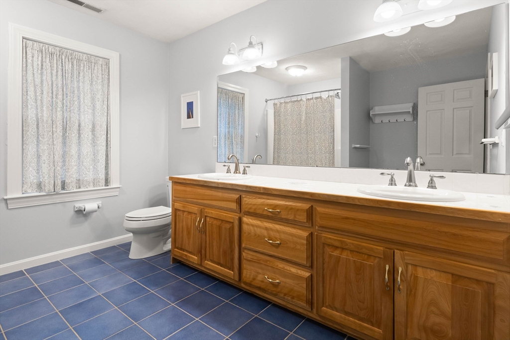 3 Woodland Road Boxford, MA 01921 - Photo 15 of 37 a spacious bathroom with a double vanity sink a toilet and a mirror