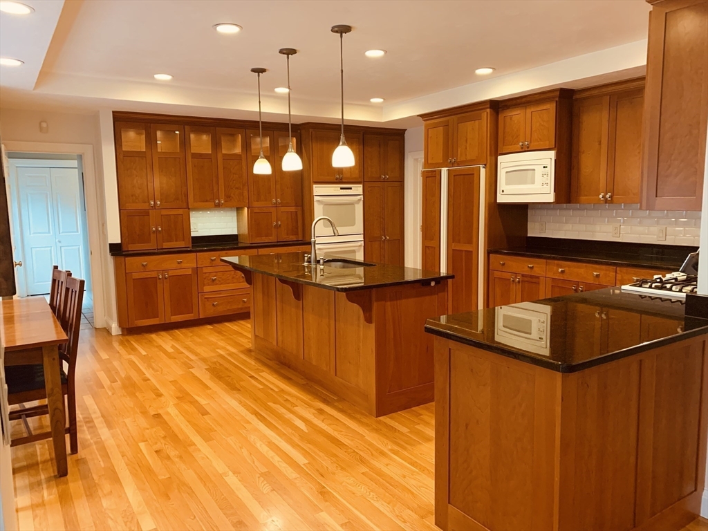 3 Woodland Road Boxford, MA 01921 - Photo 22 of 37 a large kitchen with stainless steel appliances granite countertop a stove a sink and a microwave